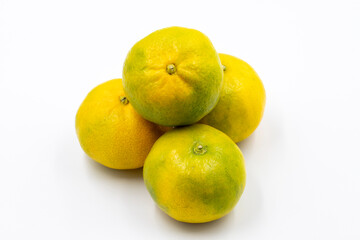 Tangerines on a white background. In combination with a shade of ripe sweet tangerine. close up