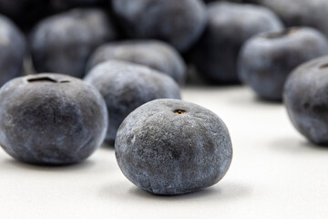 Blueberries on a white background. In combination with the shade of ripe blueberries. close up