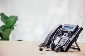 Communication support, call center and customer service help desk. telephone devices with VOIP headset in office.Customer service support (call center) concept.