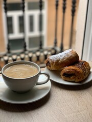 cup of coffee with croissant