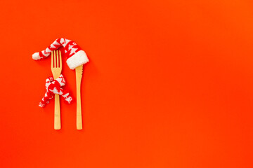 The creative concept of a festive menu mockup, diet, natural healthy food one red background. Wooden cutlery. Background for christmas,New Year lunch, dinner invitation or party with copy space