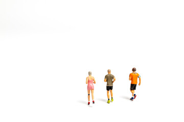 Miniature people running on white background , Healthy lifestyle and sport concepts.