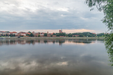 Fototapeta na wymiar Morning view on panorama of Old Town of Torun seen from the Vistula river in Poland.