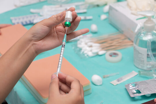 Doctor Or Nurse Drawing Vaccine Bottle Into Syringe Injection Medicine, Covid 19 Vaccine