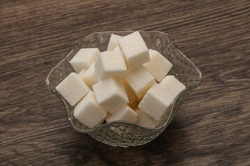 Refined white sugar cubs in the bowl