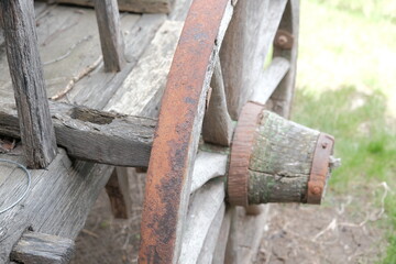 old (vintage) wooden wheel. 19th century carriage wooden wheel. antique metal parts made in the forge