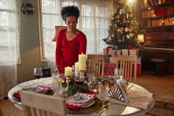 Fototapeta na wymiar Black woman serving festive holiday table