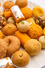 Group of Indian assorted sweets or mithai with diya