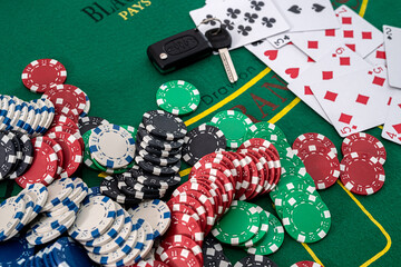 chips and cards for playing poker with risky bet with car key