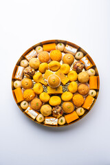 Group of Indian assorted sweets or mithai with diya