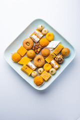 Group of Indian assorted sweets or mithai with diya