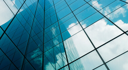 business building in city with mirror windows with reflections of blue sky.