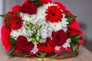 bouquet of white chrysanthemums, red roses and red gerberas