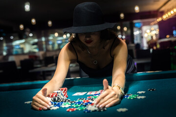 young woman in black dress win In Blackjack game and rejoicing to all chips after poker game - Powered by Adobe
