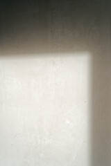 View of the concrete wall inside the room, unfinished apartment. Imperfections on the wall - cracks, sagging, dirt, crumb. Preparation for renovation and finishing work.