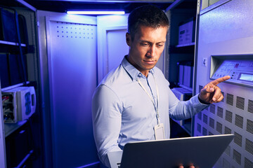 Caucasian male technician working in data center