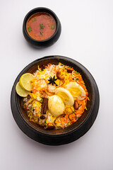 Anda biryani or egg biryani served in handi or plate
