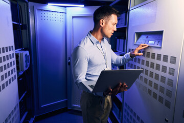 Experienced male technician monitoring server performance metrics