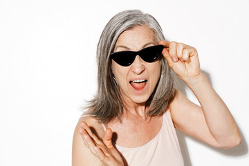 Mature woman in sunglasses gesturing while screaming at camera