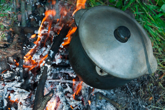 cast iron cauldron on fire. cooking on a hike. outdoor recreation concept	