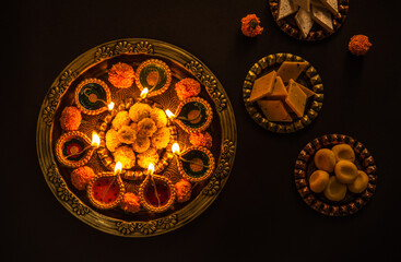 Diwali Diya with sweets in plate