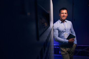 Joyful data center employee posing for camera in workplace