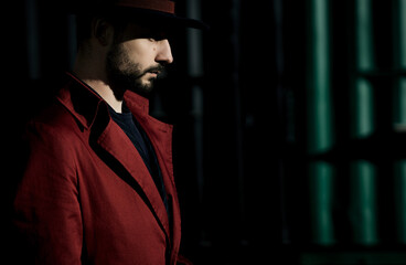man in a hat and a red coat