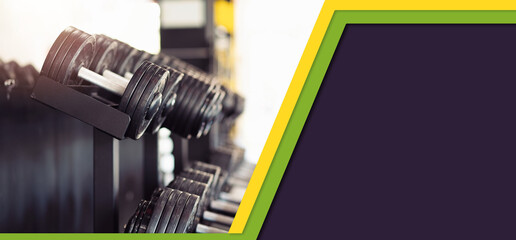 Sports web banner. Iron dumbbells lying in rows in the gym. Copy space