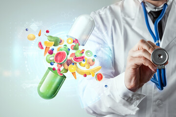 Food supplement in the form of medicinal capsules with fruits and vitamins on the background of the doctor. Correct diet, diet, alternative medicine, vitamins, naturopathy, homeopathy