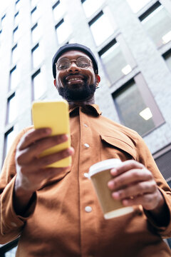 Smiling man using smart phone
