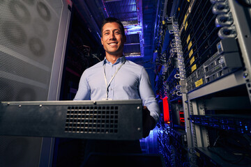 Smiling pleased engineer demonstrating new hardware component
