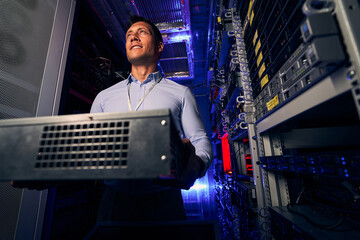 IT technician holding new hardware component in his hands