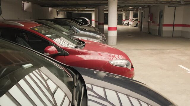 Cars parked inside a covered underground parking lot