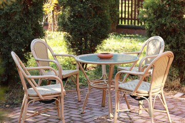 a table with chairs in the summer garden