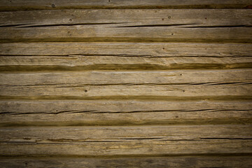 Obraz premium Wooden logs of an old house. Close-up. Weathered natural gray wood texture. Background. Horizontal photo