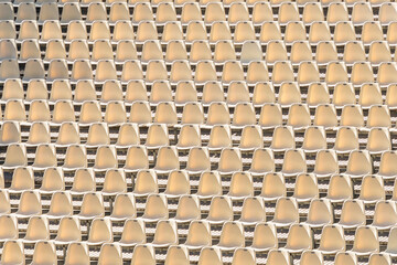 background of row of chairs in an open air theater as pattern an symbol for organization