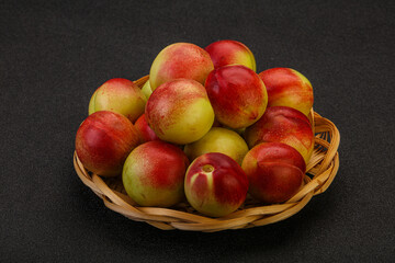 Sweet small nectarines in the basket