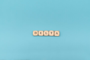 Covid-19 delta word on wooden cubes. Covid-19 delta word withon blue background. Sars covid-19...