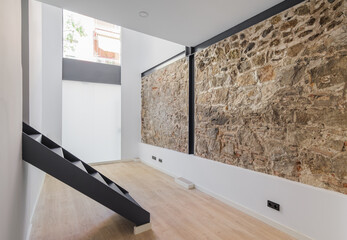 Interior of empty renovated room in a duplex flat. Mix of new and old architecture. Refurbished...