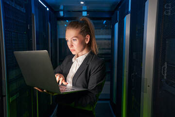Fototapeta na wymiar Young attractive woman working in server room