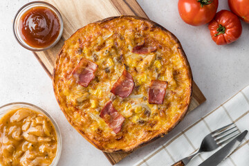 Overview of cheese, bacon, onion, chicken and bbq sauce pizza