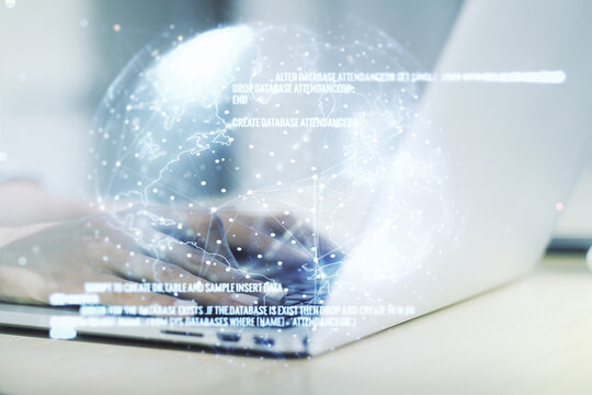 Double exposure of abstract programming language hologram with world map and hands typing on laptop on background, research and development concept