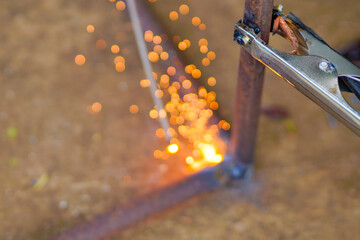 Fototapeta na wymiar Welders working and jointing iron pipe at the factory