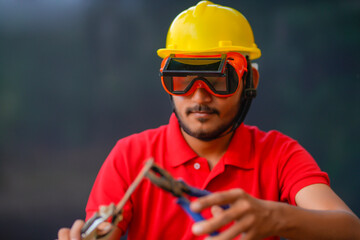 Young indian welder working at iron factory