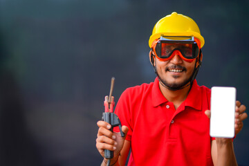 Young indian welder working at iron factory