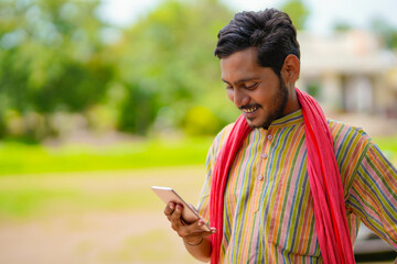 Fototapeta premium Indian auto rickshaw three-wheeler tuk-tuk taxi driver man using smartphone.