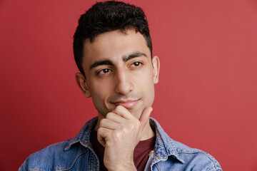 Young middle eastern man smiling and looking aside