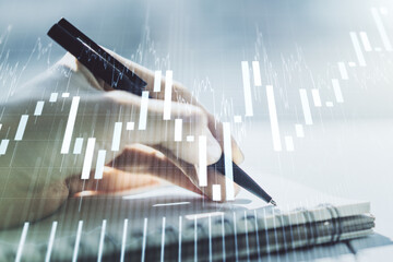 Abstract creative financial graph with hand writing in diary on background, financial and trading concept. Multiexposure