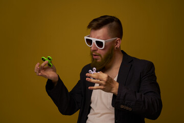 man wearing sunglasses spinner in hands fashion posing black jacket