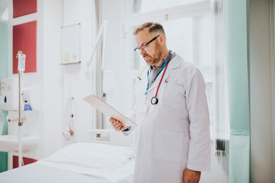 Doctor Reading A Patients Medical Chart